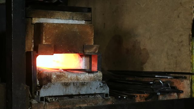 Making the sword out of metal at the forge.Hot metal billets in the furnace.