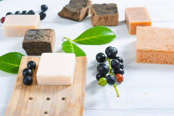 salt and milk soaps, hair colourant henna blocks on white wooden table