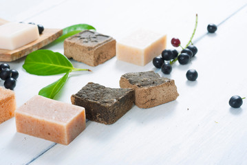 salt and milk soaps, hair colourant henna blocks on white wooden table