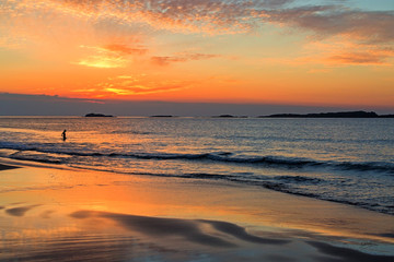 Obraz premium Evening Dip Lone Bather At Sunset Portrush