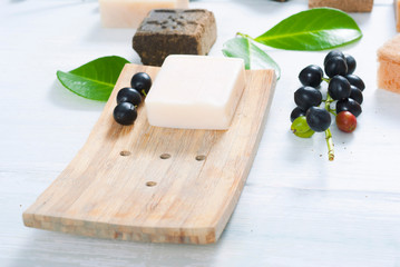 salt and milk soaps, hair colourant henna blocks on white wooden table