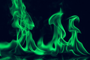 Beautiful fire green flames on a black background.