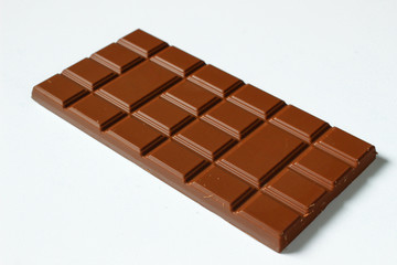 Tile of milk chocolate close-up on a white background