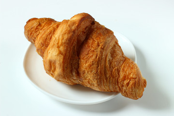 Croissant on a saucer close-up