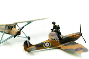 Miniature people : team soldier  standing together with army tank and aircraft air combat using for...