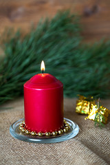 Lighted candle on wooden background, christmas