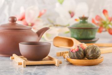 brown ceramic teapot with cups on special wooden coasters is prepared for a traditional Asian tea ceremony
