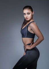 Beautyfull fitness woman in black at the studio