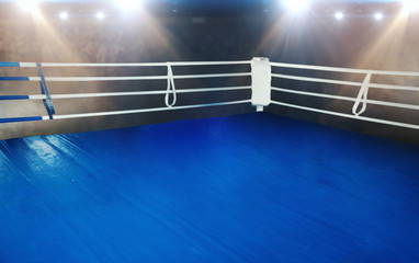 Boxing ring with blue flooring and white ropes