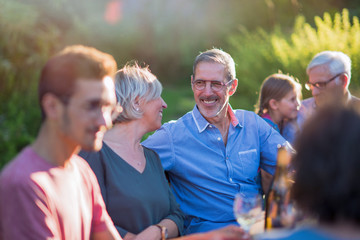 Family picnic. Focus on a handsome grey hair man 