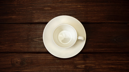 empty white cup on a dark wooden table background