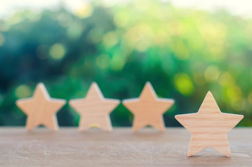 Four wooden stars. The concept of rating and evaluation. The rating of the hotel, restaurant,...