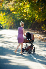 Beautiful woman walking with infant