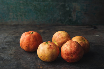 Lemon with rosy pulp on rustic background