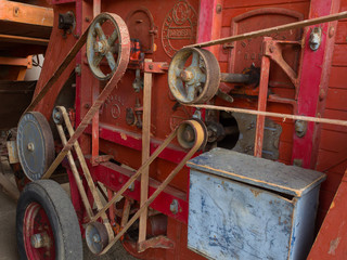 Detail of belt transmission  on an old thresher machine - 230091013