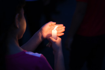 child holding a candle