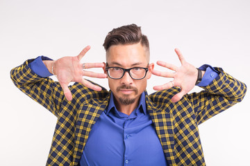 People, fashion and expression concept - portrait of a young funny stylish hipster bearded man on a white background