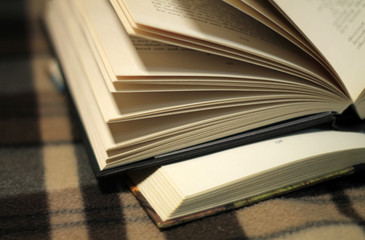 pile of open books on black background