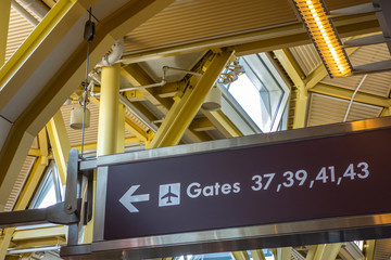 Arrival airport gates sign with arrow.