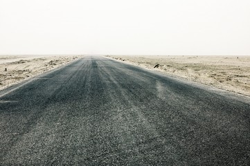 straight desert road leading to the distant void