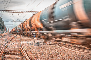 Freight train rushes with motion blur. Toned.