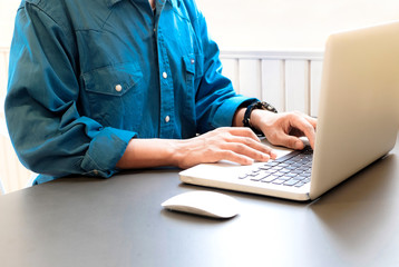 Close up of business man hands using laptop computer