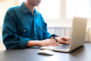 Close up of business man hands using laptop computer