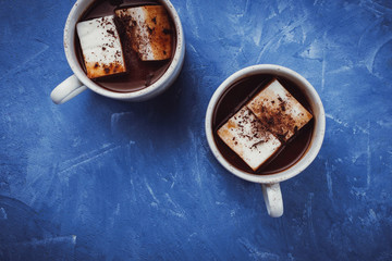 Flat lay of two cups of cocoa or hot chocolate with homemade vegan marshmallow