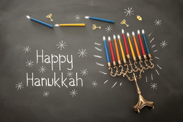 image of jewish holiday Hanukkah background with traditional menorah (traditional candelabra) and burning candles.