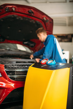 Mechanic connects air conditioning system