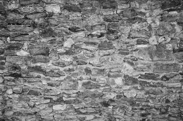 Black-and-white Texture of an old stone wall. Closeup