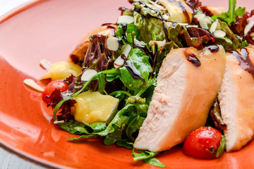 Spring salad. Wooden table background.