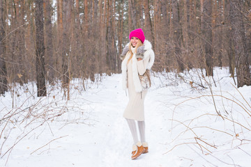 Nature, fashion and people concept - Young attractive blond woman posing in the winter park.