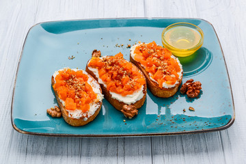 Tasty savory Italian appetizers, or bruschetta, on slices of toasted baguette garnished with basil