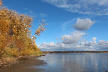 autumn landscape with lake and blue sky
