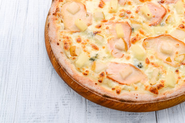 Pizza with ham, apples and pineapple