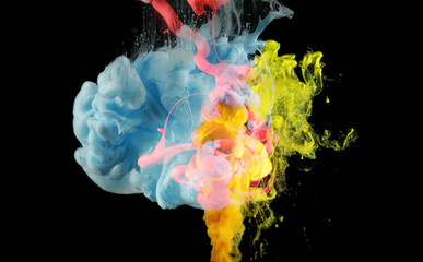 Acrylic colors in water. Ink blot. Abstract background on black.