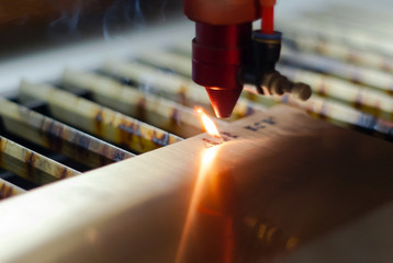 stage of manufacturing, laser engraving in automatic mode, close-up, blurred background
