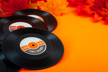 Nostalgic songs, fall music and melancholy concept with vintage vinyl records surrounded by autumn...