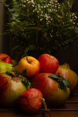 Fruits composition in Autumn (pomegranates, piers, apples)