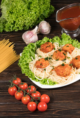 pasta with meat and chili tomatoes on wooden background