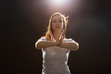 Young woman jazz funk dancer exercising dance moves in studio