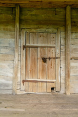 Old wooden door in the ancient structure of the boards. Secret or hidden information