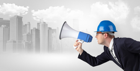 Fototapeta premium Young supervisor architect yelling to far big city panorama 