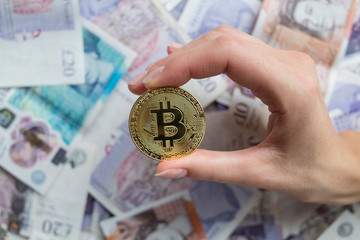 Female hand holding a bit coin in the hand.