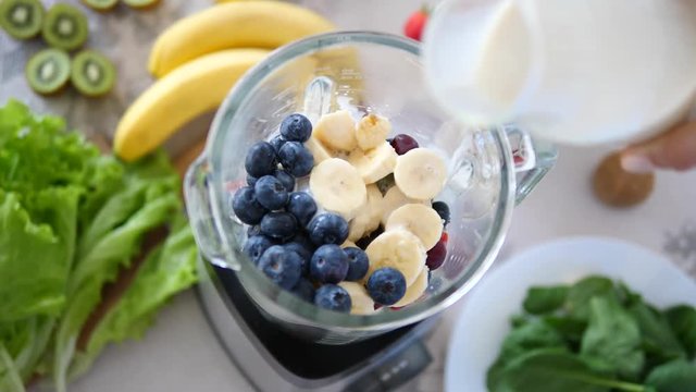 Pouring Oat Milk In Blender With Vegan Smoothie From Fruits And Berries
