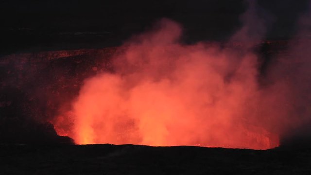 Kilauea Volcano night lava glow smoke from crater Hawaii National Park. Most active volcano in the USA. Smoke, steam, gasses. On the Big Island in Volcano National Park. Small eruptions and lava flow.