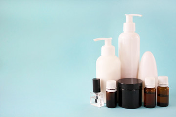 Banks and containers with cosmetics on a blue background. Cosmetic products, brand beauty concept,...