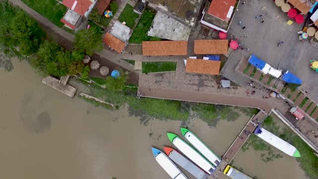 Aerial drone shot of passengers getting of a boat and walking on a pier