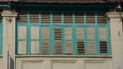 Beautiful blue windows of old shophouse in George Town, Penang